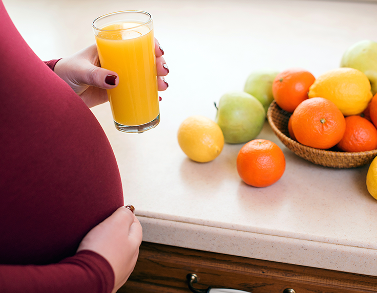 Pregnant Women having drink fruits, juices for her and a baby inside the womb